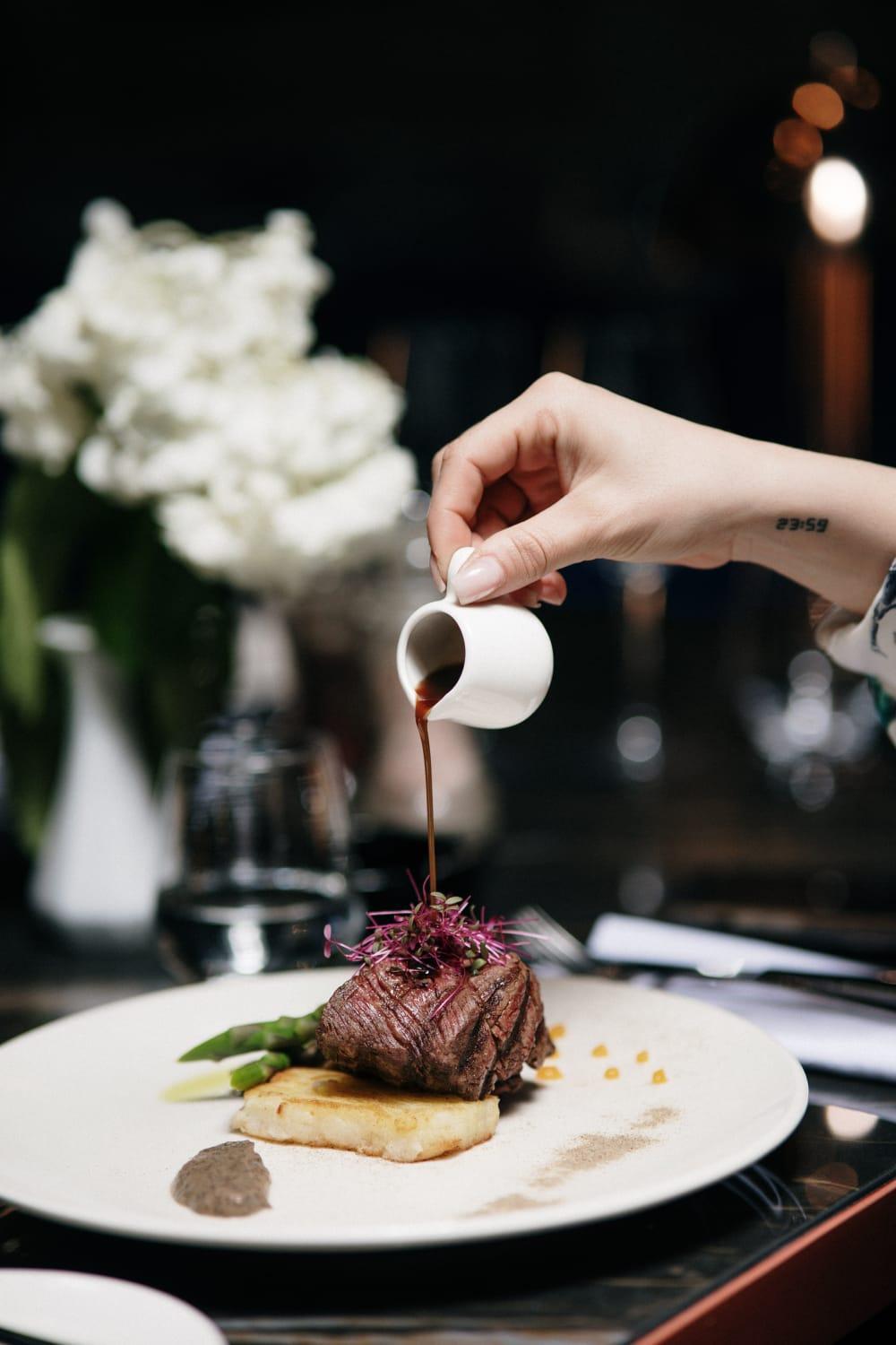 Xheko Imperial Luxury Hotel & Spa Tirana Kültér fotó A server pours soy sauce onto a dish